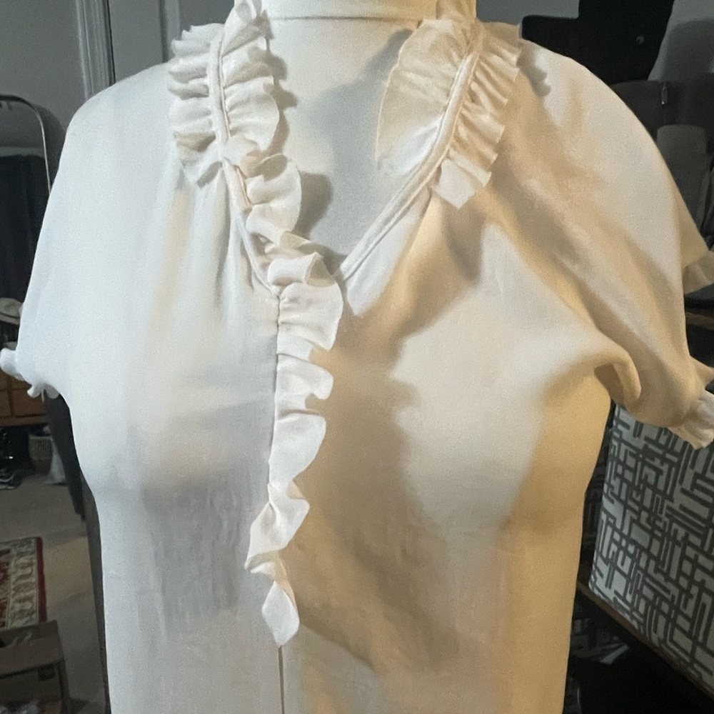 Marc Cain ivory feminine ruffle v neck blouse. Cap sleeve with ruffle. Very soft